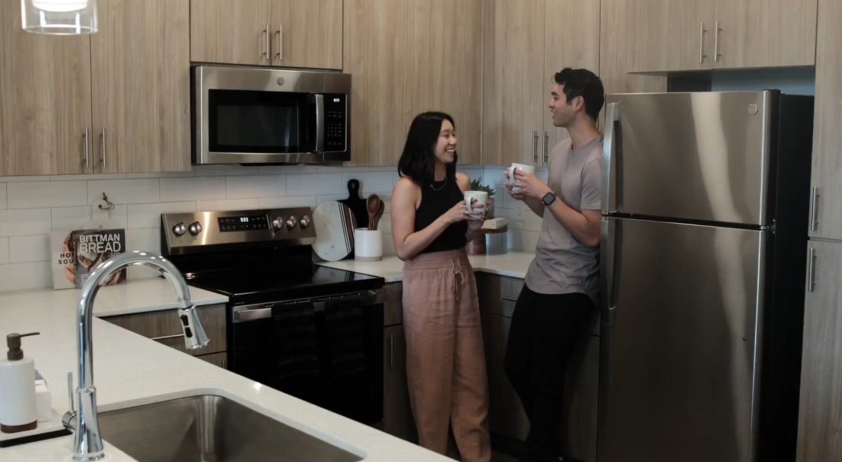 a couple in a kitchen