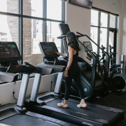 a woman walking on a treadmill