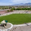 a park with green grass with a playground and mountains in the distance