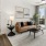 a living room with a couch and a coffee table and laundry room