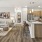 a large kitchen and living room with a wood floor