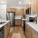 a kitchen with wooden cabinets and white countertops