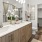 a bathroom with a large mirror a sink a toilet and a closet
